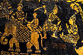 Wat Xieng Thong temple in Luang Prabang, Laos. Detail of the  intricate gold stencilling on black lacquer that decorate the walls of the sim.